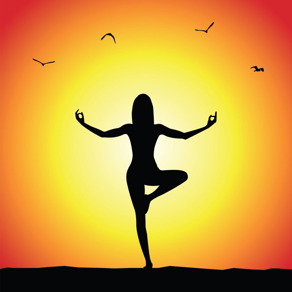 yoga pose silhouette on sunset background